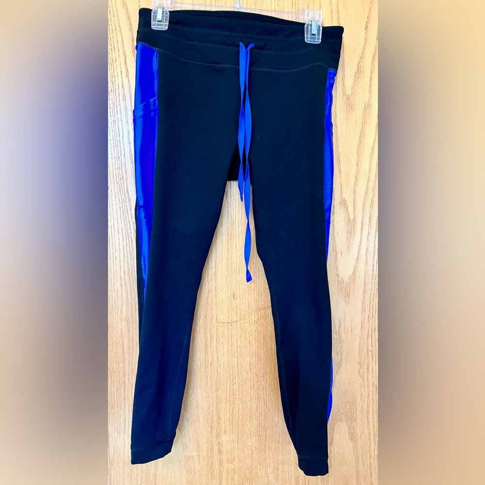 Size Medium capri Powerhold by Fabletics, black with blue striping